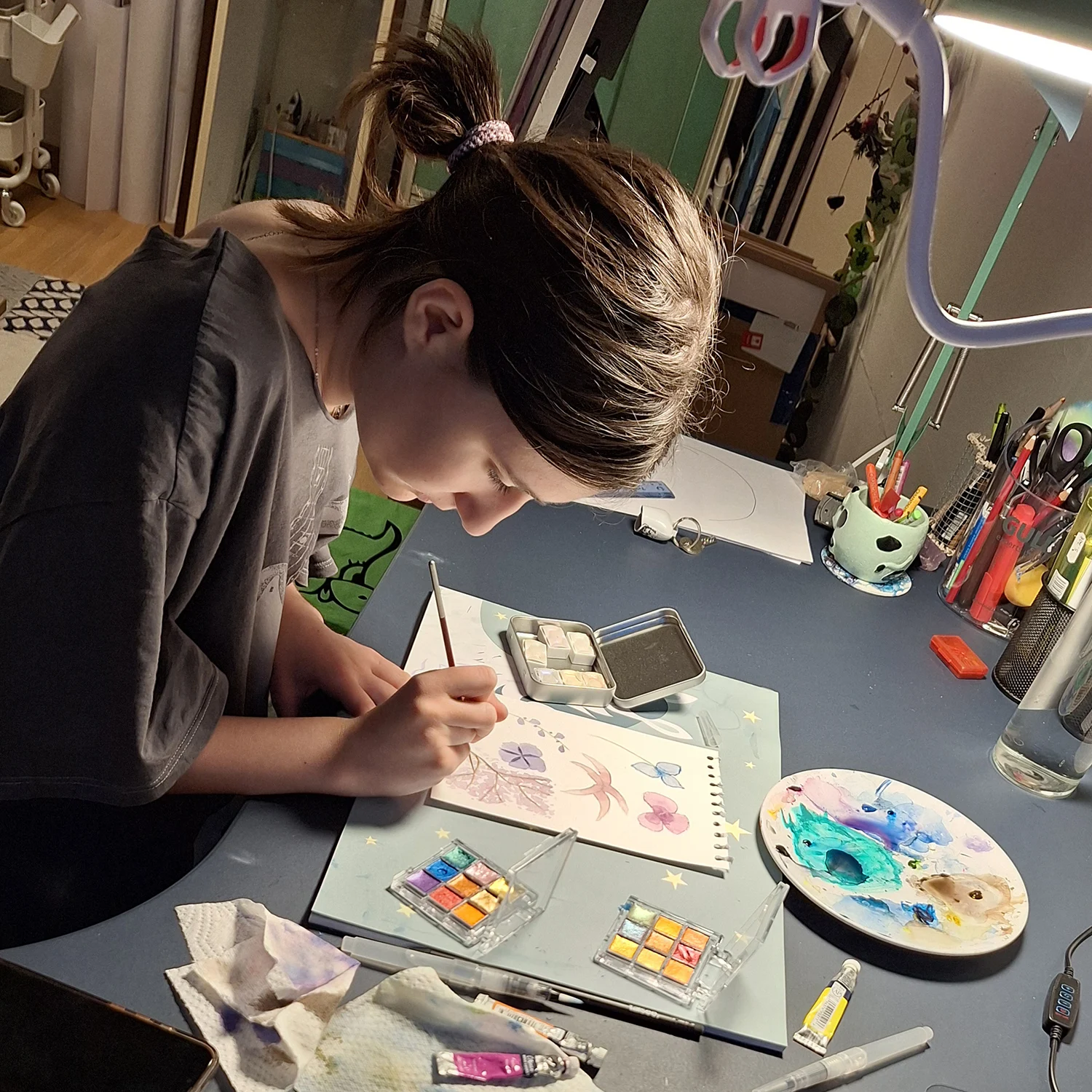 Child focused on creating art in the studio